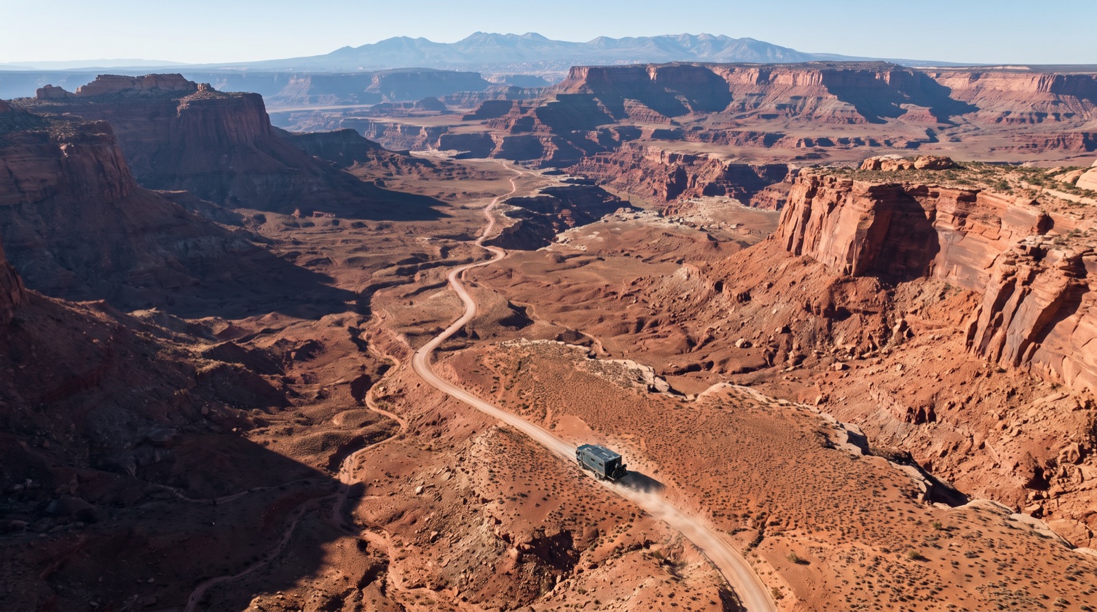 Aerial view of a truck on a red-rock canyon road