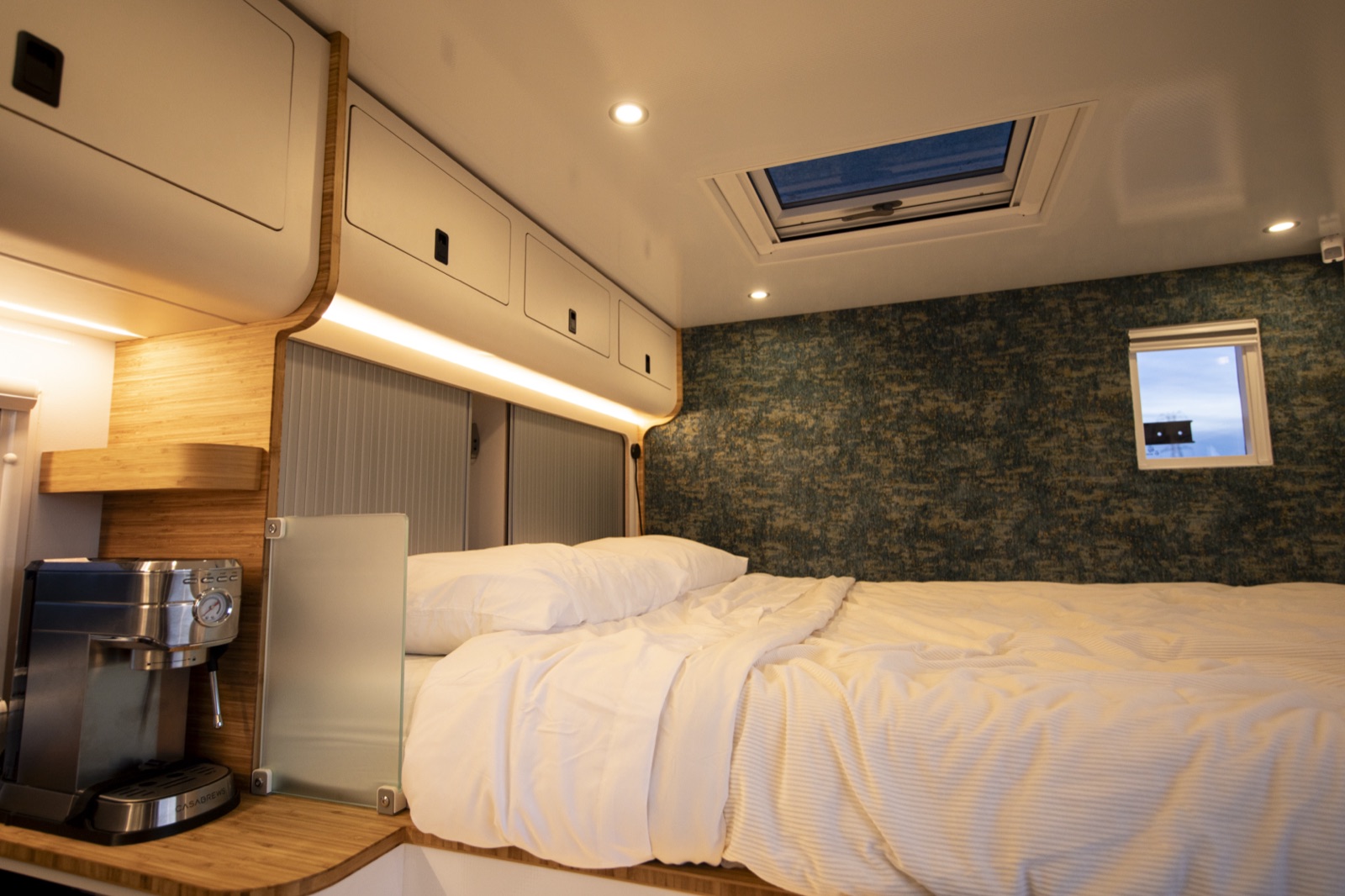 Bedroom with bamboo cabinetry and skylight